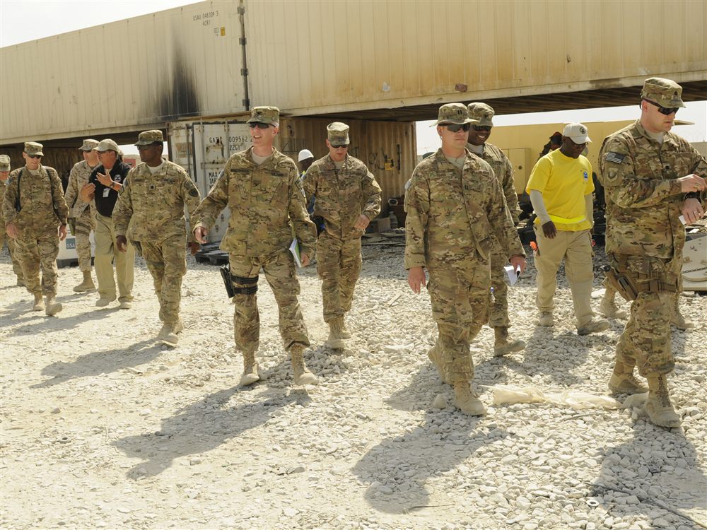 Defense logistics personnel reviewing supply operations at a federal distribution center