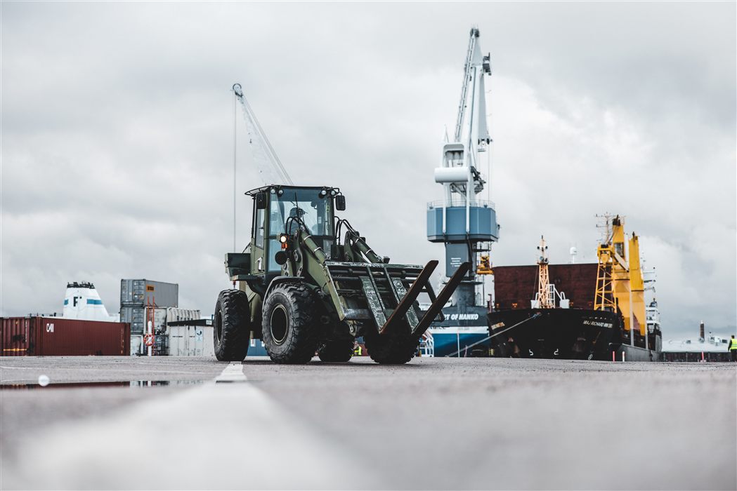 Military wheeled loader and port cranes staging for combat engineering operations
