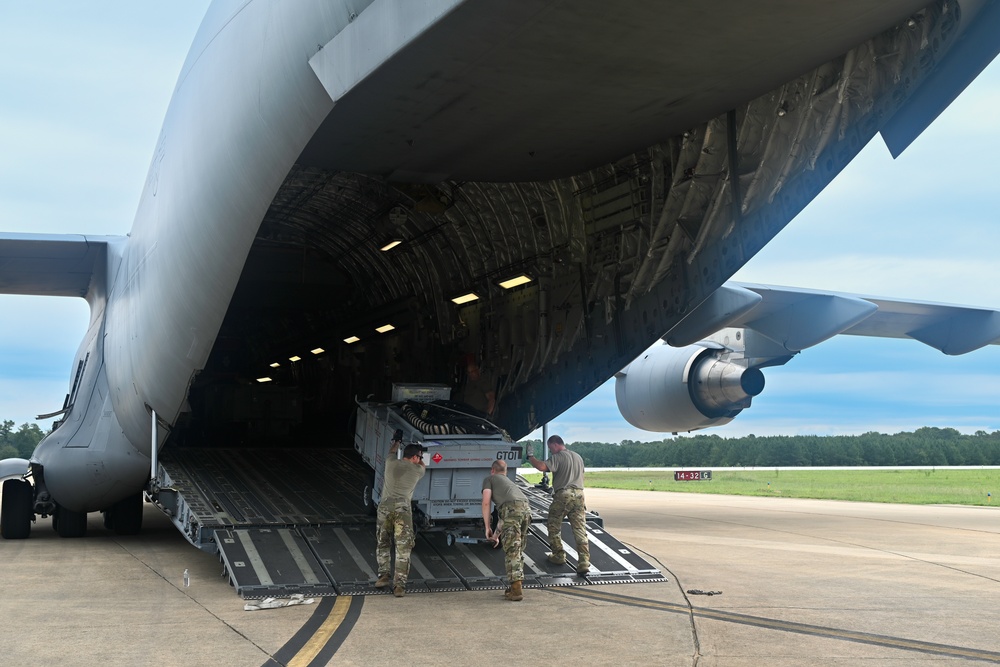 U.S. military Airmen loading industrial cargo for federal supply operations