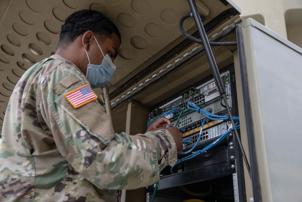 U.S. Army Soldiers setting up tactical communications hardware in field operations